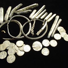 Close up of gold coins securely stored in a vault or safe.